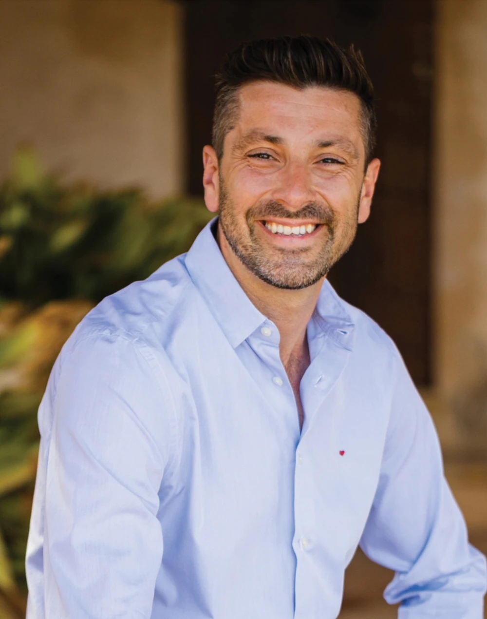 Julian Cunningham-Bond wearing a blue shirt smiling 