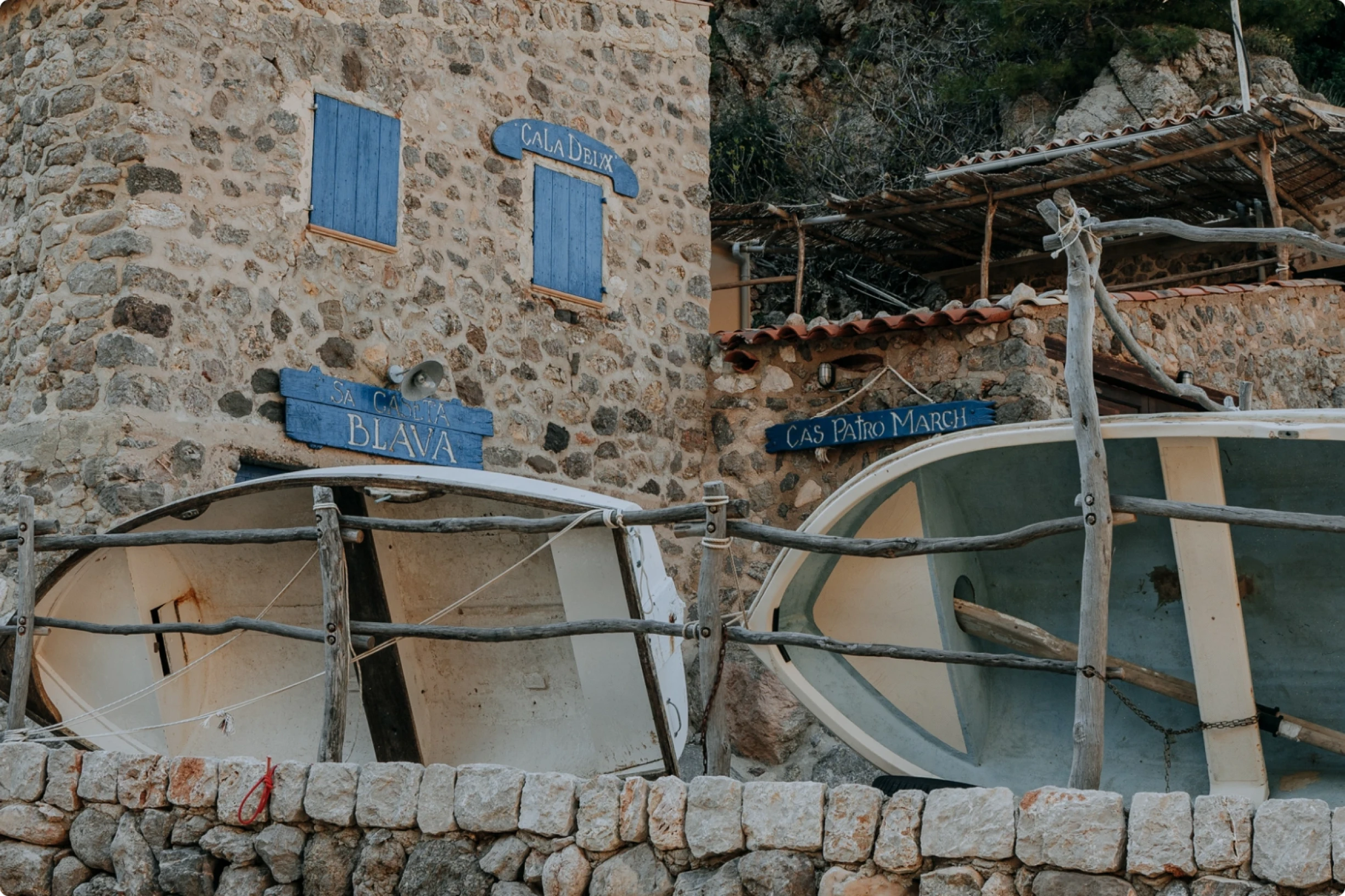 An image of two boats outside a boat house