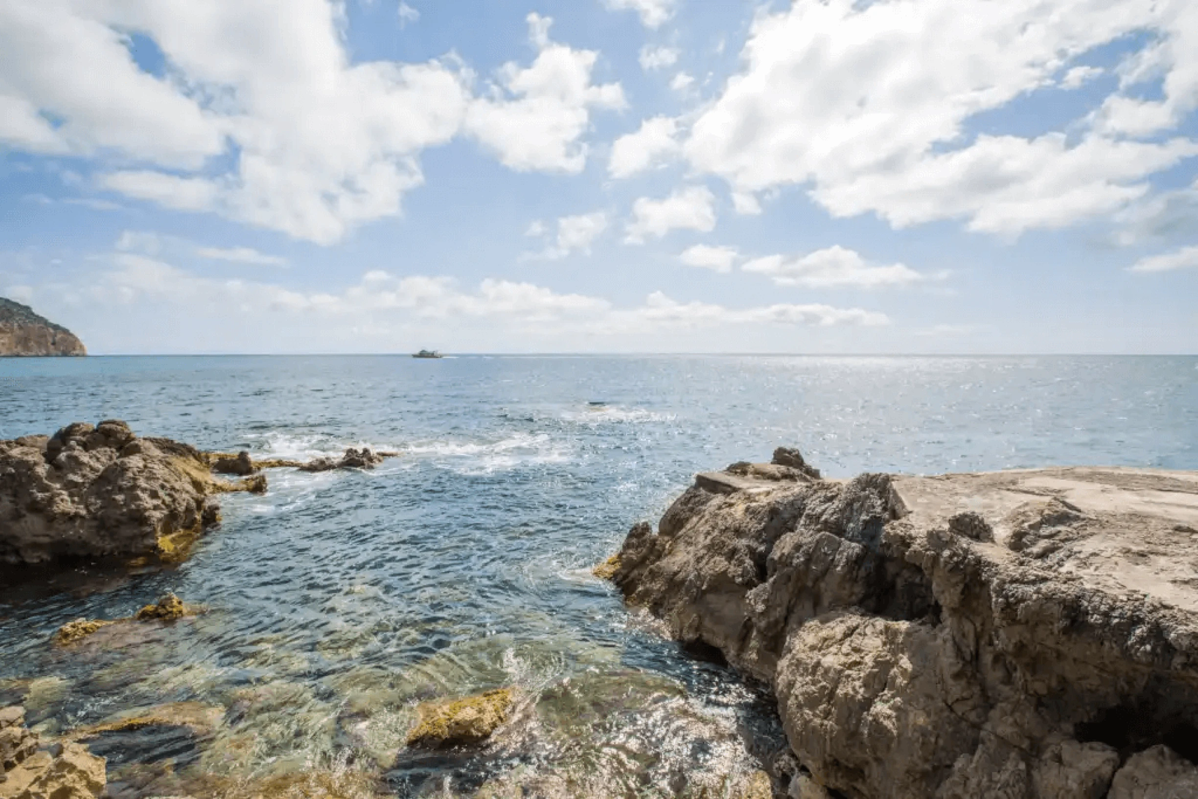 Rocky coastline and sparkling Mediterranean sea in Canyamel, Mallorca