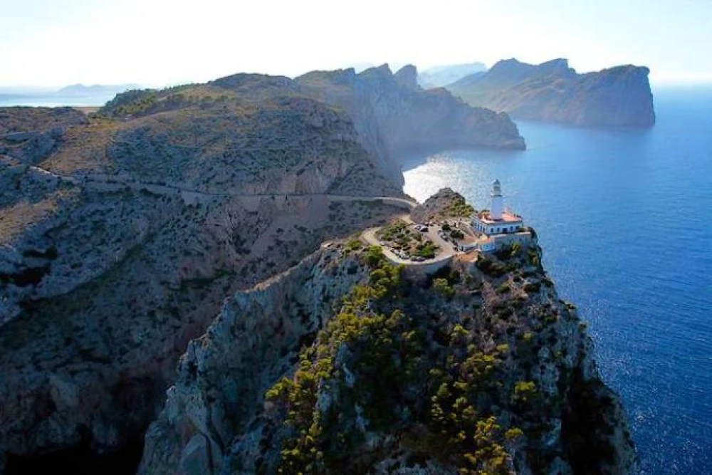 Aerial view of the iconic Formentor lighthouse on a rugged cliffside