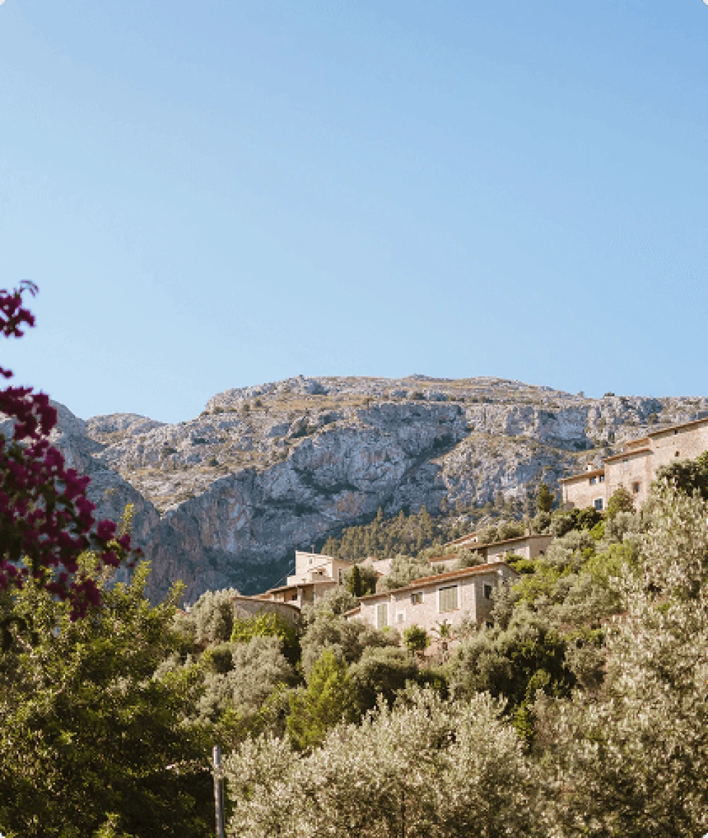 Traditional stone village of Fornalutx set against a mountain backdrop