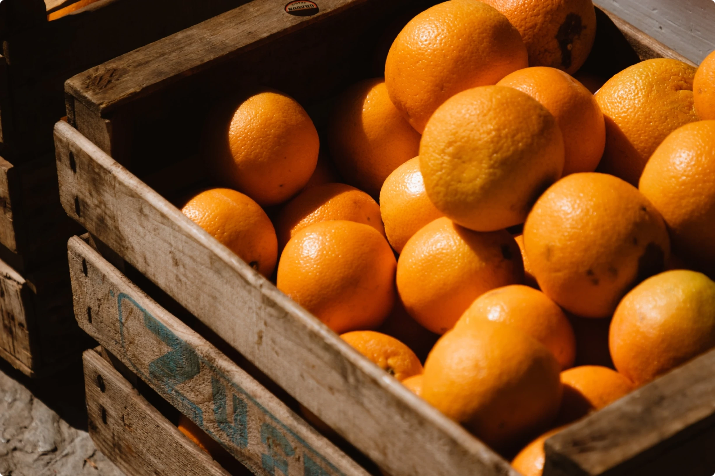 A wooden box of oranges